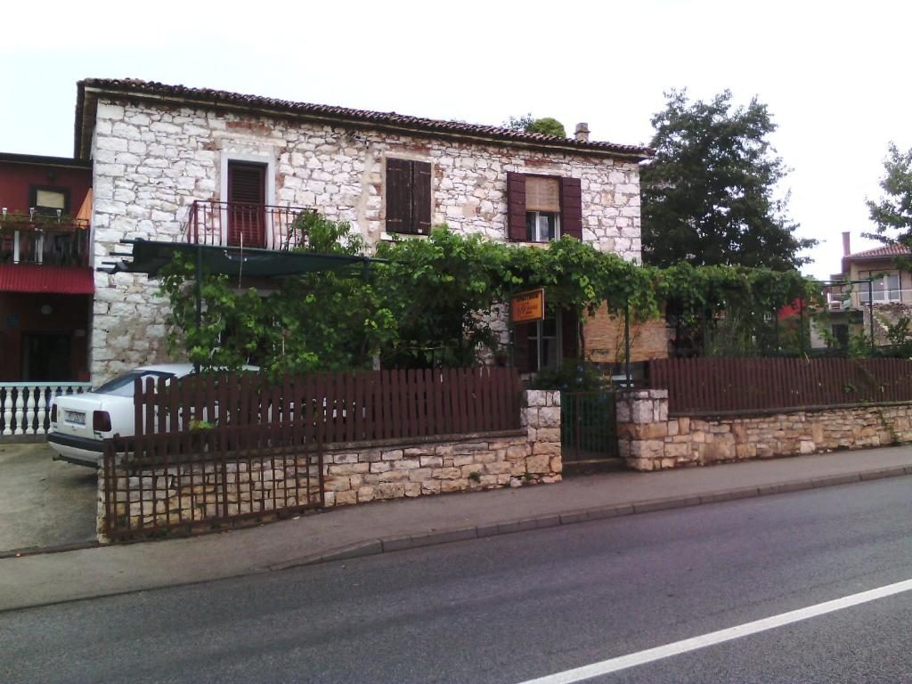 Stara istarska kamena kuća Apartments Katarina u Umagu, s pergolom u dvorištu